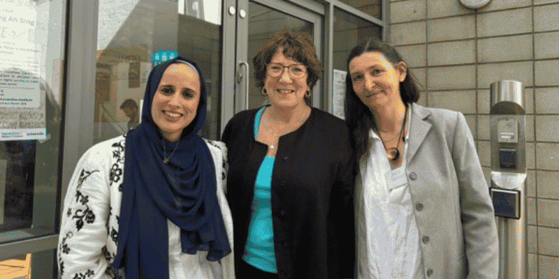 Three women smiling at the camera