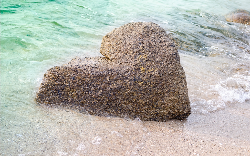 shore line with large love heart shaped stone