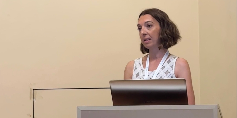 Woman speaking behind a podium