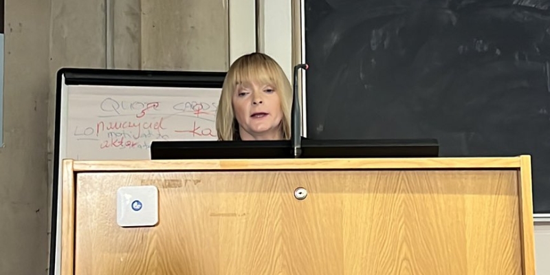 Close up of a woman speaking behind a podium