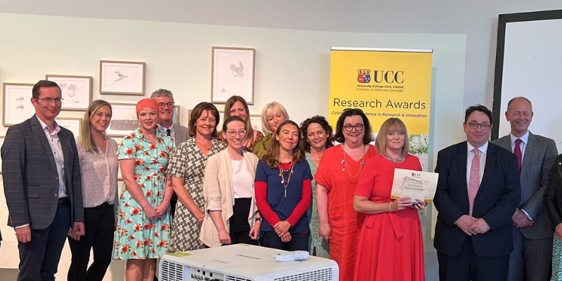 Large group of people standing together after receiving Research Team of the Year award