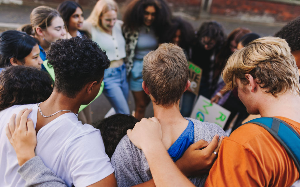 Group of young people standing in a circle