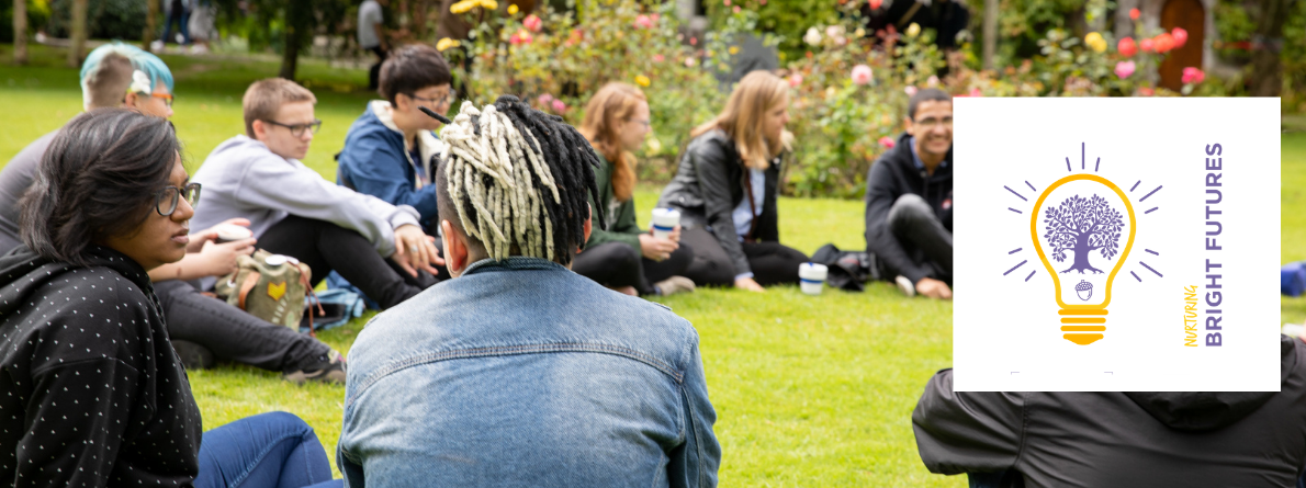 Student conversing outside in a circle