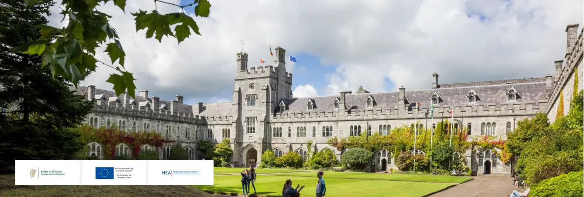 A wide shot of the quad on UCC campus on a sunny day. There are logos on the image for the Government of Ireland, the European Union, and the Higher Education Authority