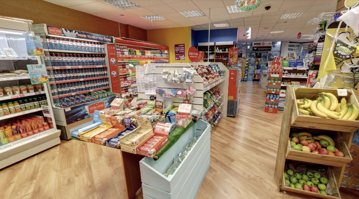 A photograph of the inside of An Siopa. Convenience snacks and drinks along two rows in the shop