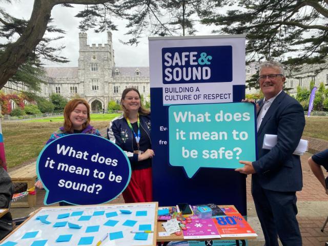 Chloe Boland, Dr Caroline West and President John O'Halloran holding Safe and Sound signs