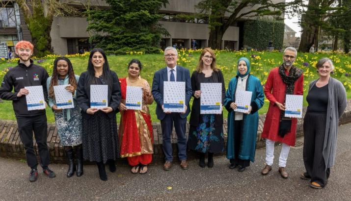 A line of people holding copies of the Race Equality Action Plan, some of who are wearing traditional dress. A line of people holding copies of the Race Equality Action Plan, some of who are wearing traditional dress.