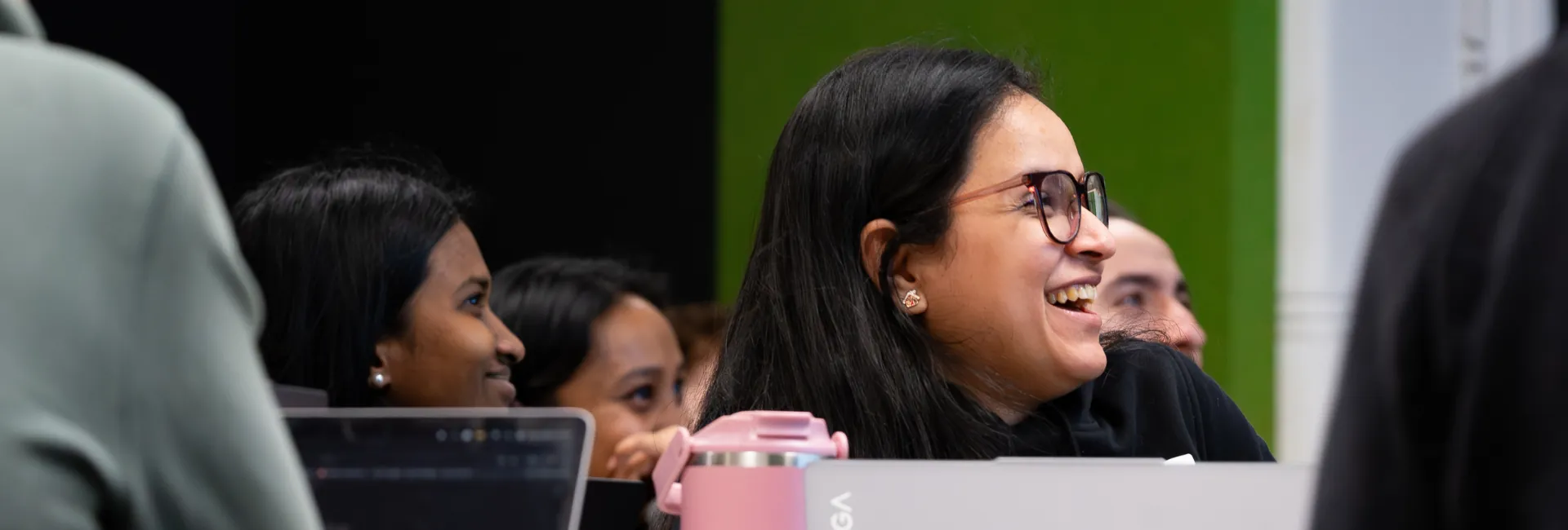 Image of women sitting and smiling