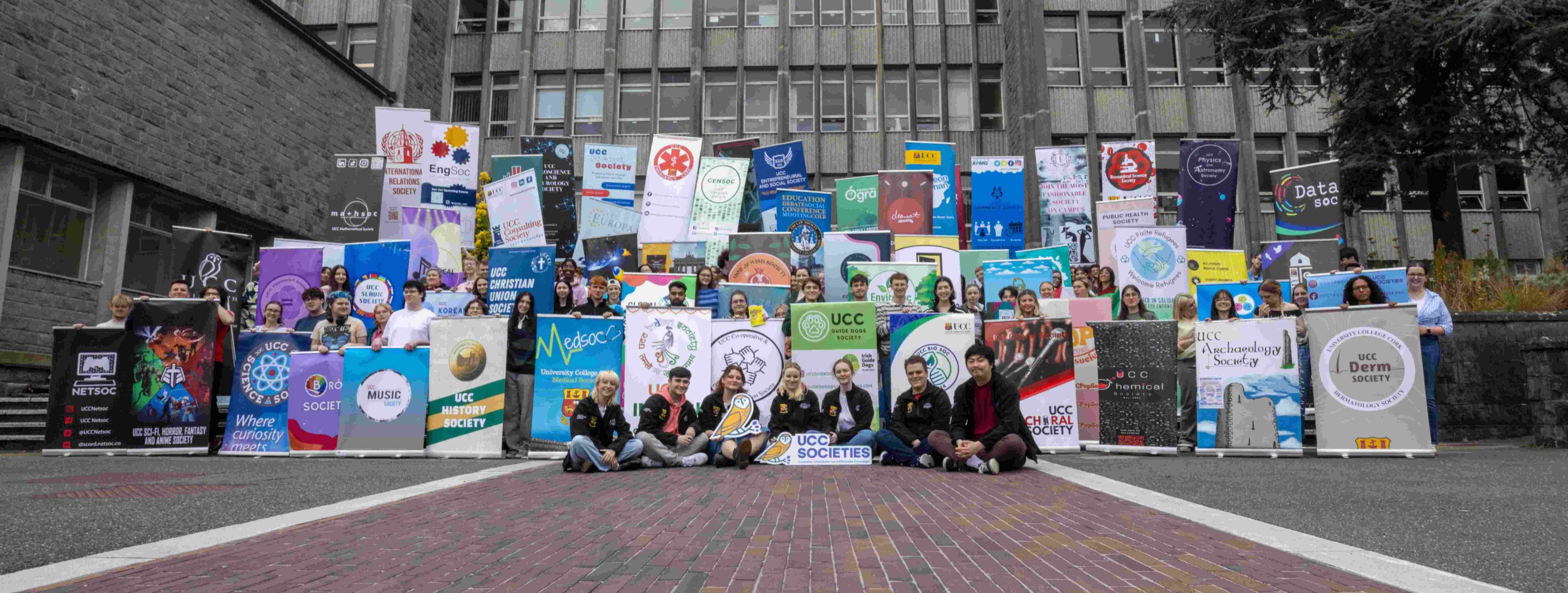 All UCC societies with their banners in front of the Kane building in UCC