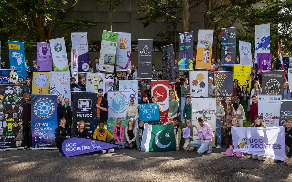 A large group of people standing in front of the quad at UCC