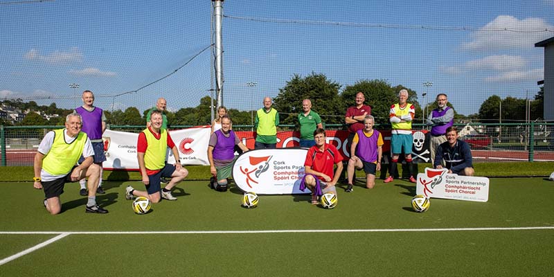 Members of the community posing for a photo to illustrate the Walking Football idea
