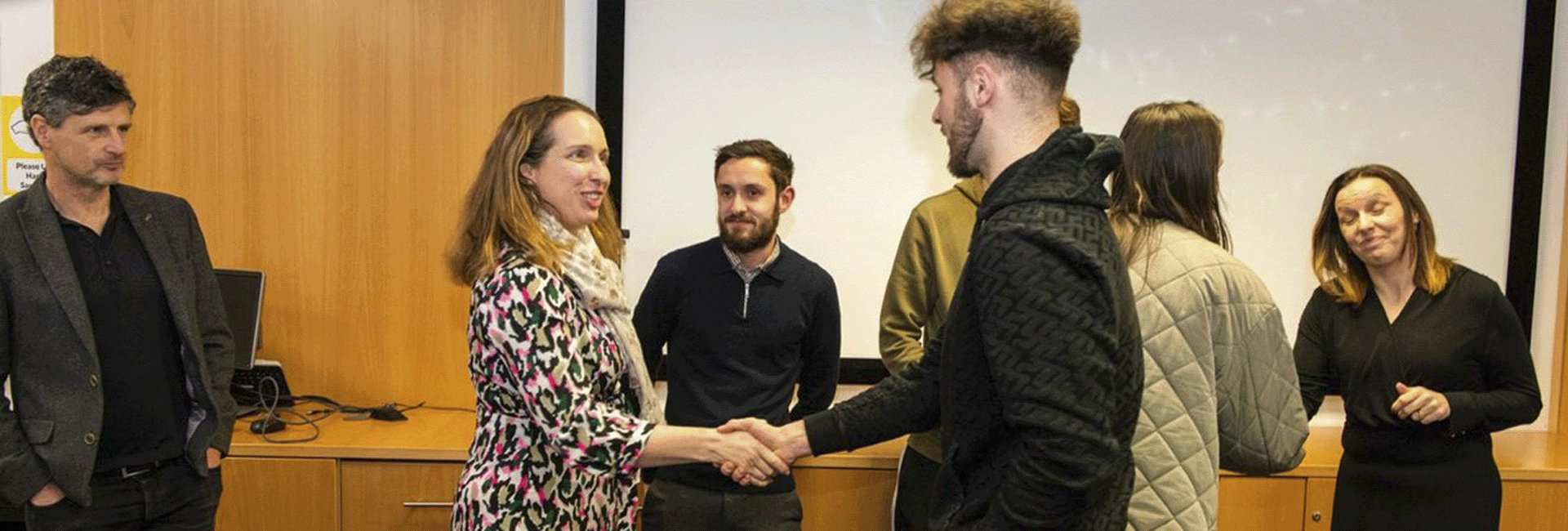 Several people networking in a room