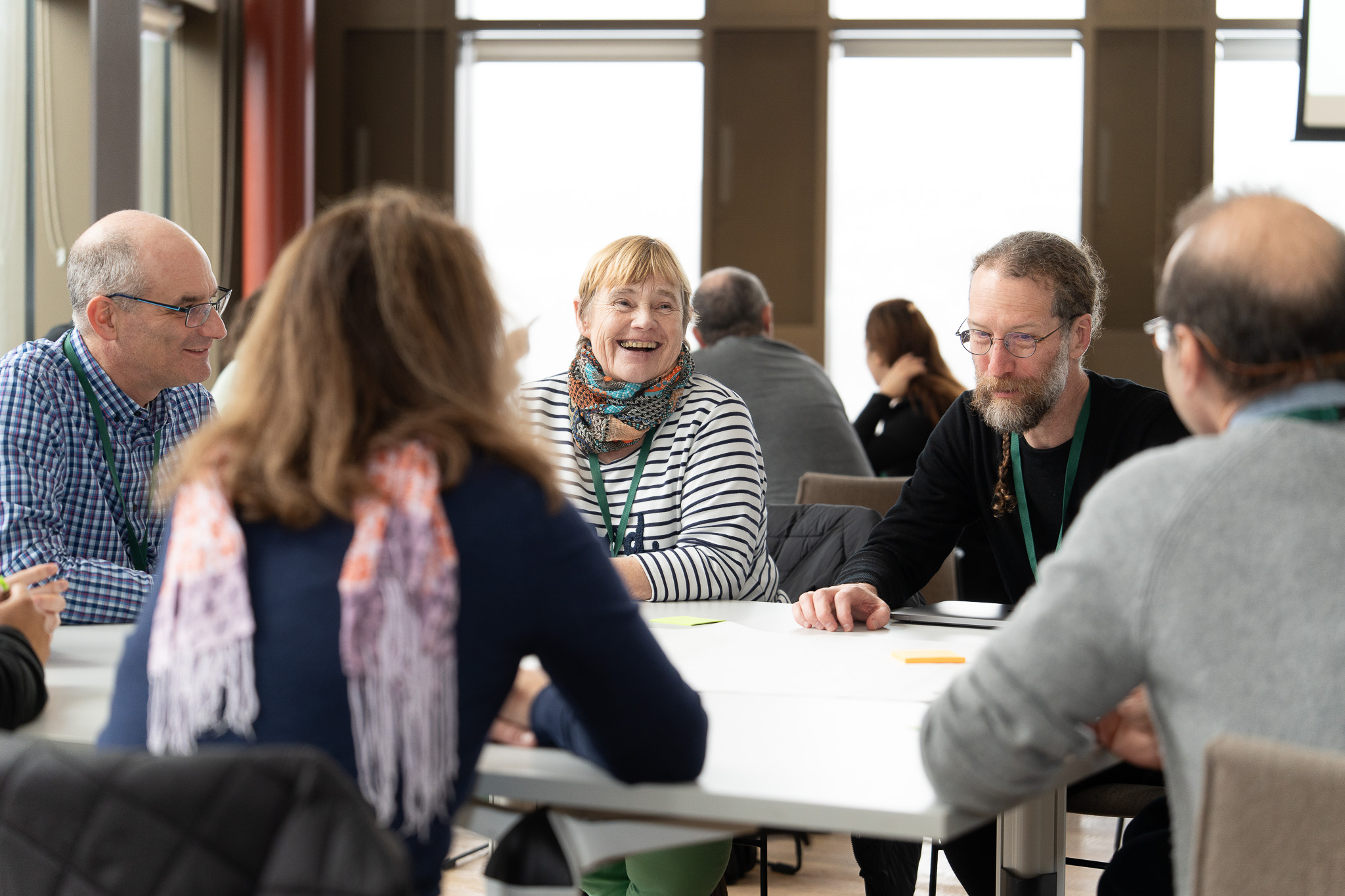 Group of people having a discussion around a table