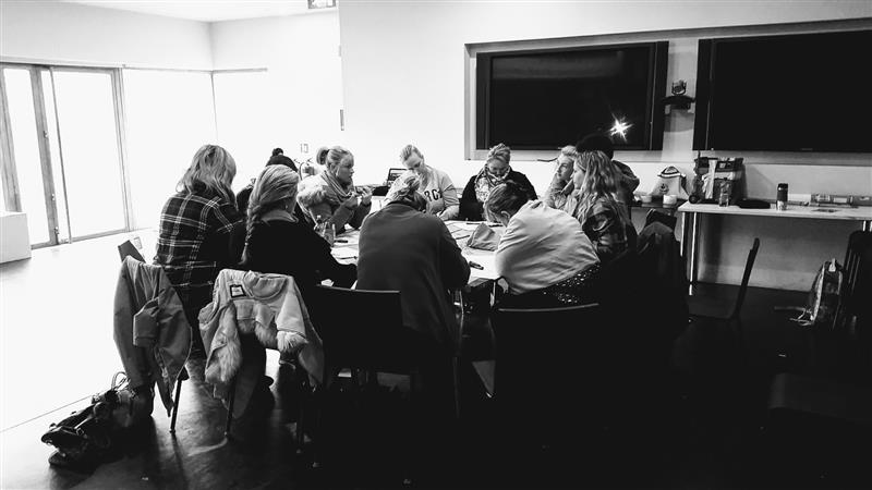 black and white image of traveller students engaging in group workshop