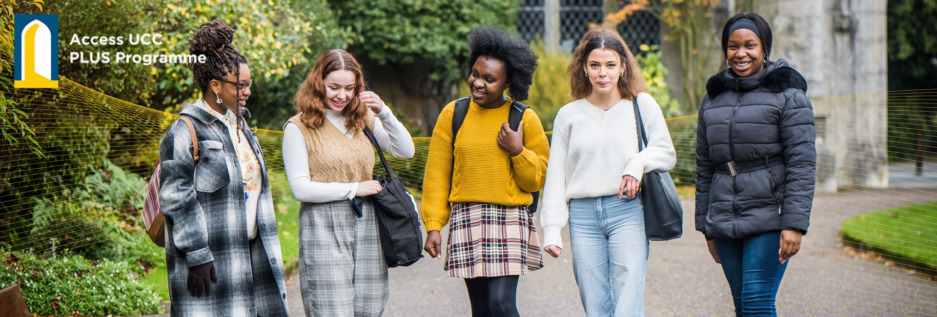 PLUS Programme Decretive Banner | Four Students walking by the Quad UCC