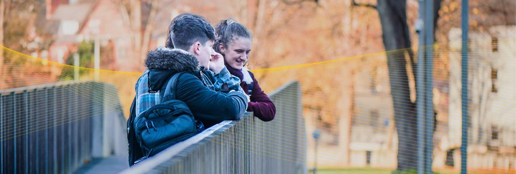 Access UCC Photoshoot - Three students looking over a bridge in UCC