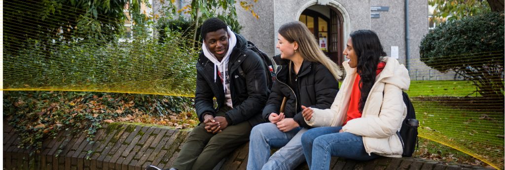 Access UCC Photoshoot - Four students walking and talking by the QUAD UCC