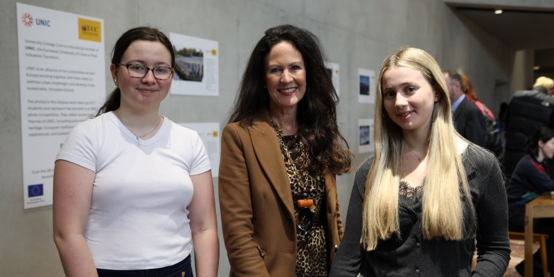 UNIC Director Dr Jean van Sinderen-Law and UNIC student reps Sadhbh Tierney and Margarita Linetska at the opening of the UNIC photo competition display in the Student Hub. 