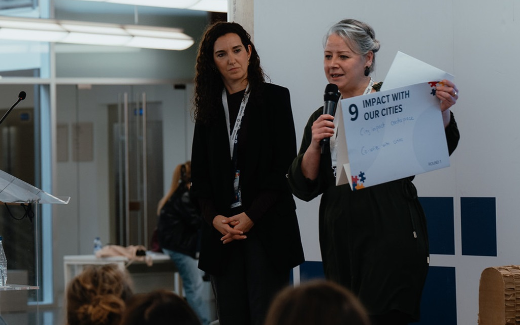 two speakers presenting a topic related to impact with our cities