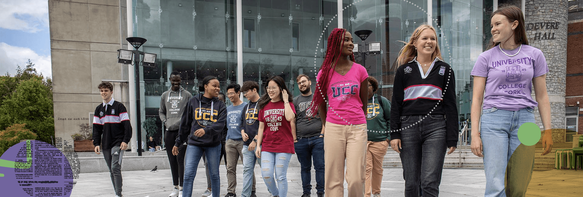 Several young men and women on college campus wearing UCC branded clothing